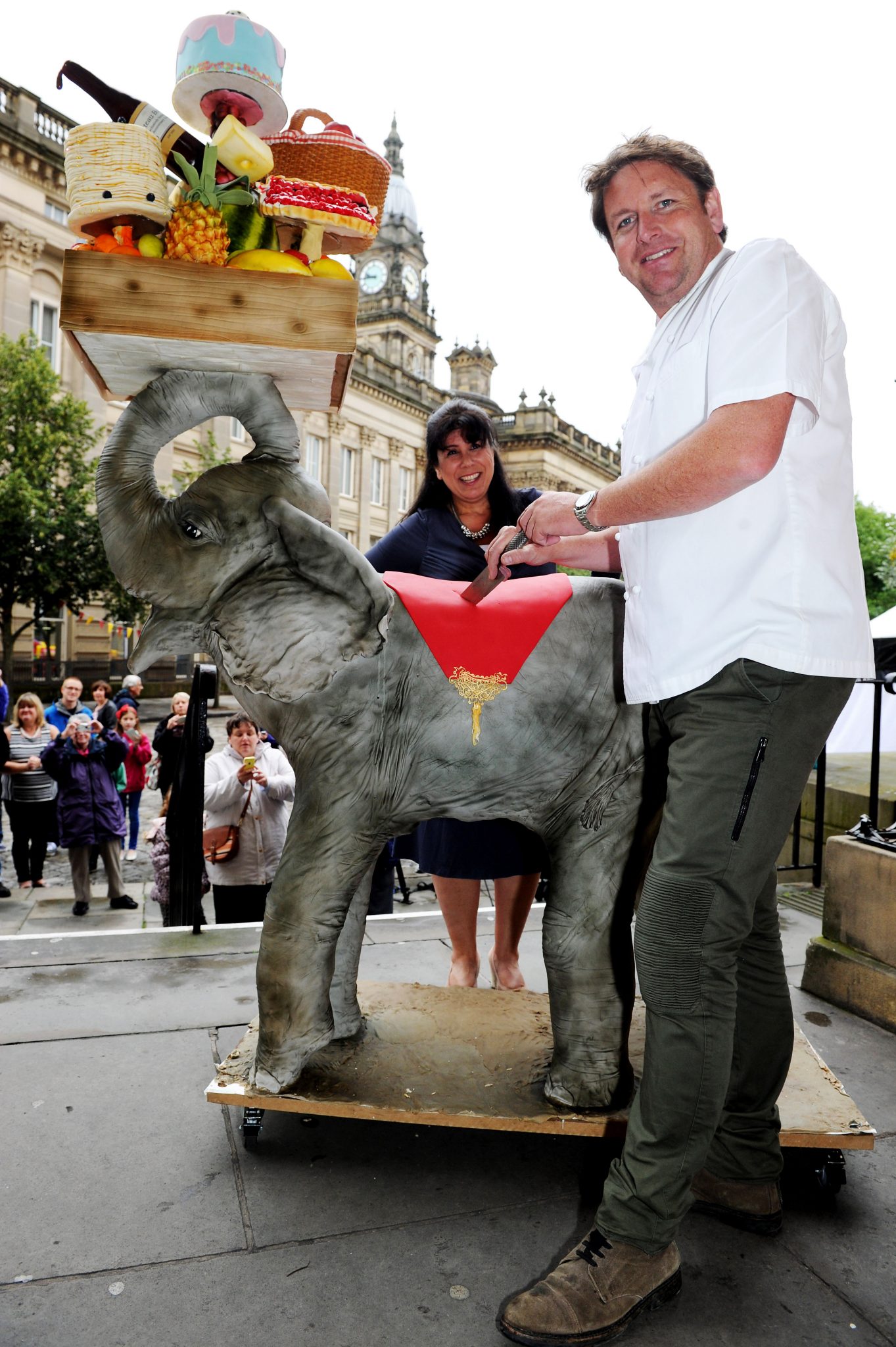 The 10th annual Bolton Food and Drink Festival, Victoria Square, Bolton, Lancashire. Celebrity chef James Martin cuts into the 10th anniversary cake with maker Rosie Dummer. Picture by Paul Heyes, Monday August 31, 2015.