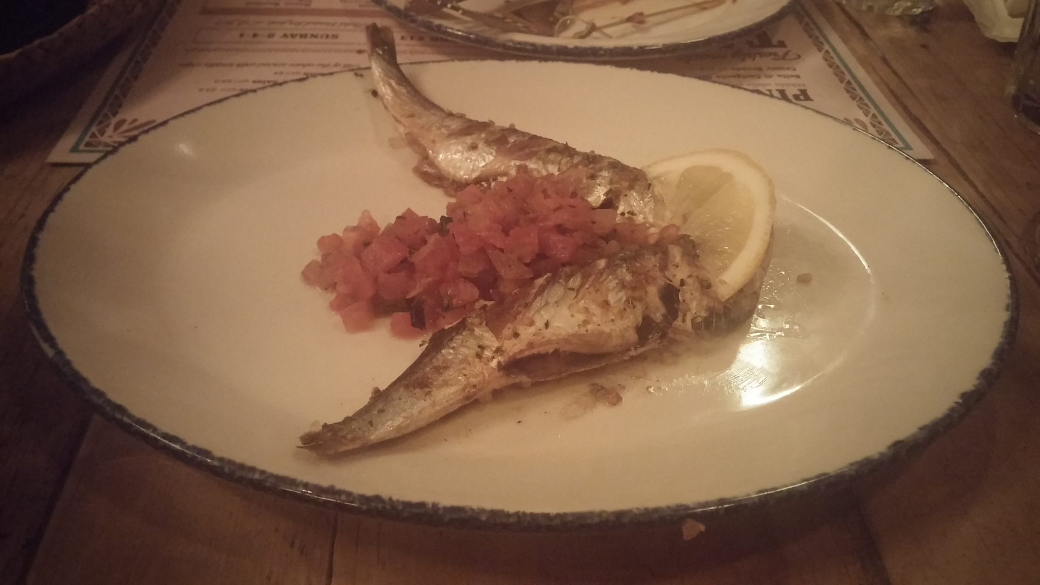 whole grilled sardines topped with smoky tomato salsa
