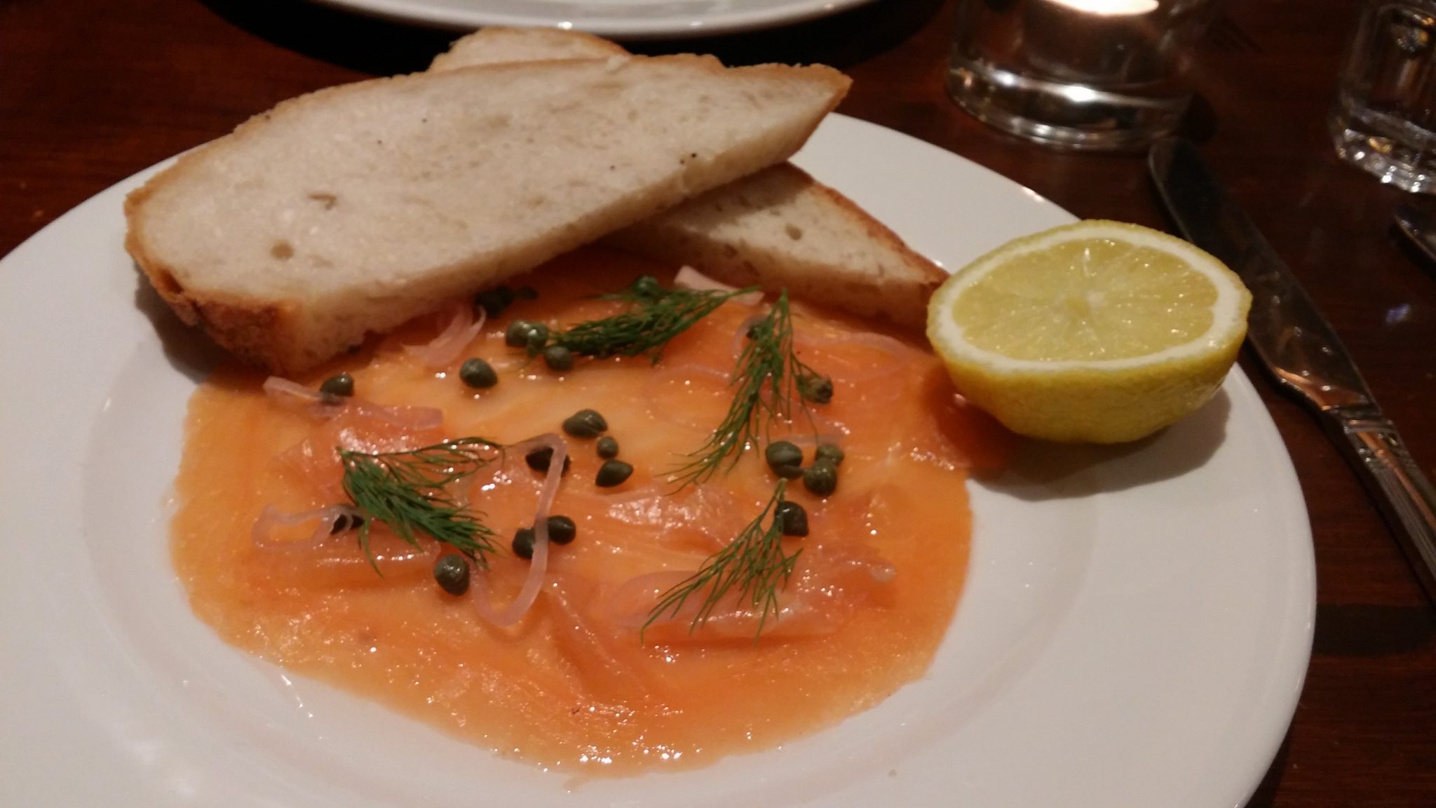H. Foreman & Sons Scottish Smoked Salmon (with shallots, Lilliput capers, lemon), slice of sourdough.