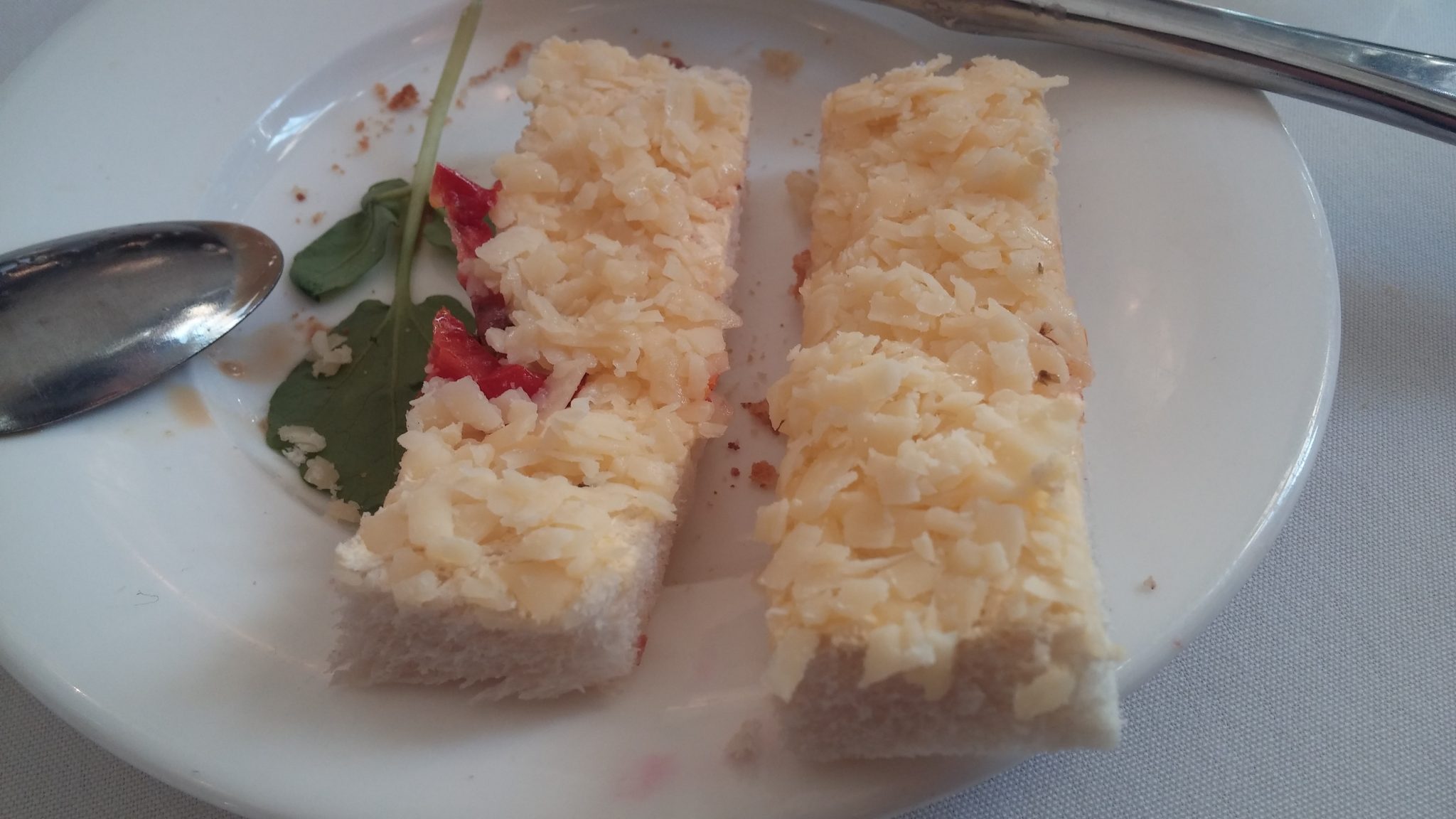 Grated cheese and bitty tomato sandwich on dry bread