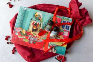 A gin advent calendar sits on a red gift bag