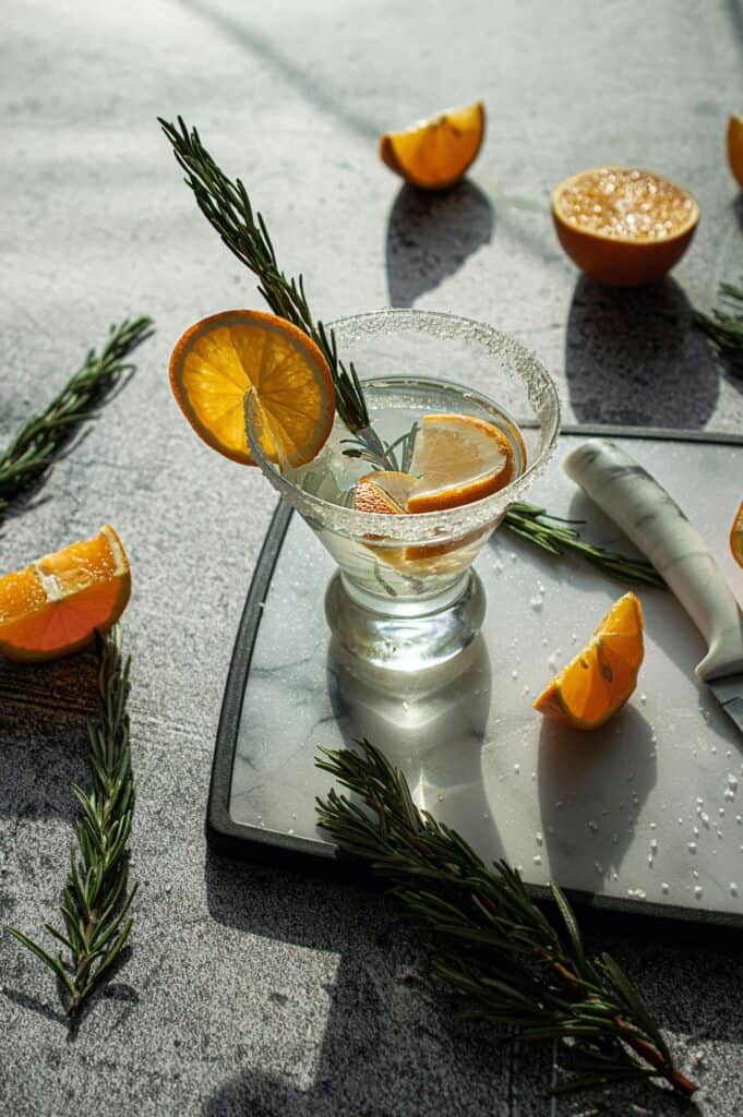 CHRISTMAS TIPPLES FROM MASTER OF MALT 4 A cocktail glass is filled with a gin cocktail and garnished orange slices