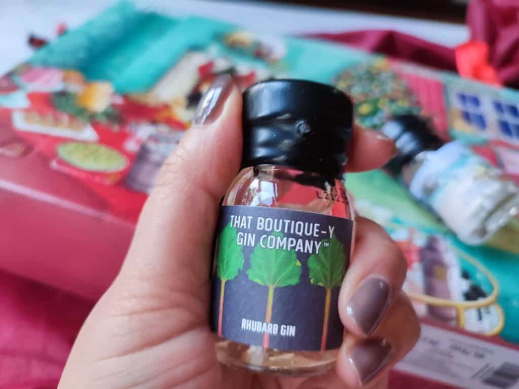 CHRISTMAS TIPPLES FROM MASTER OF MALT 2 A hand holds a dram contained in the gin advent calendar