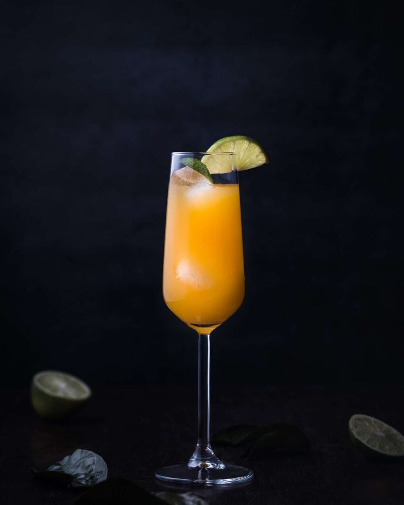 CHRISTMAS TIPPLES FROM MASTER OF MALT 7 A cocktail is served in a tall glass with a lime wedge garnish