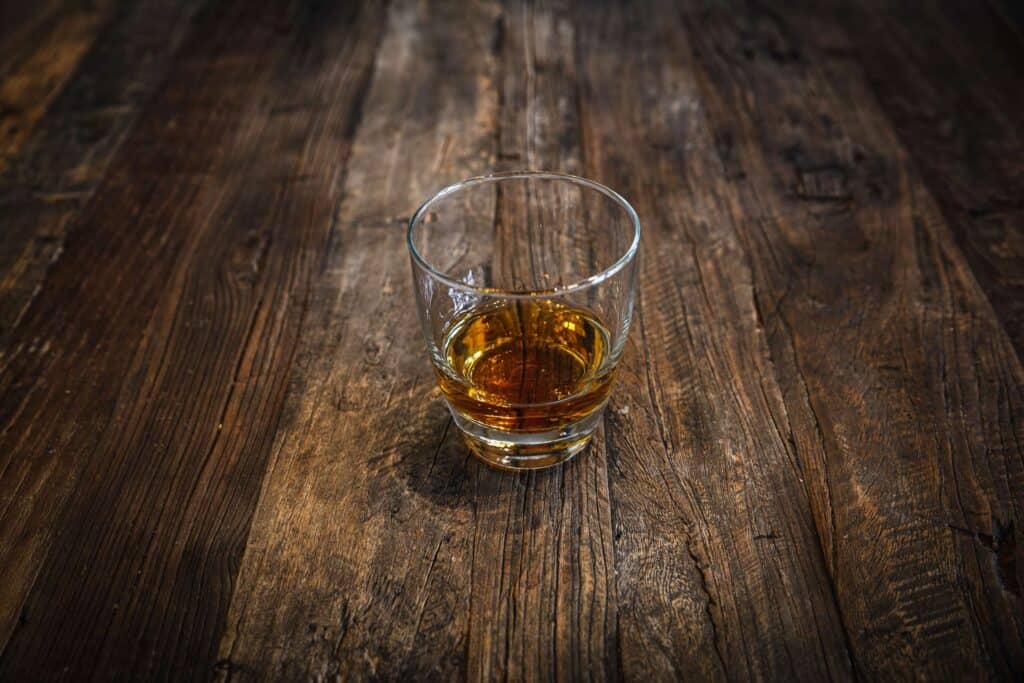 CHRISTMAS TIPPLES FROM MASTER OF MALT 6 A glass has a shot of rum and is served on a wooden table