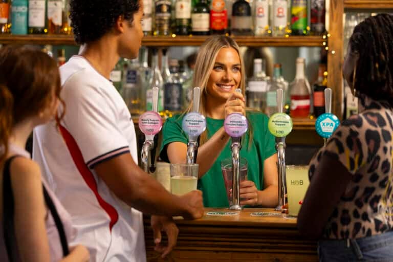 Man and woman in pub drink at the bar