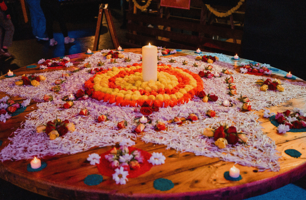 Rangoli celebrating Diwali filled with rice, flowers and candles